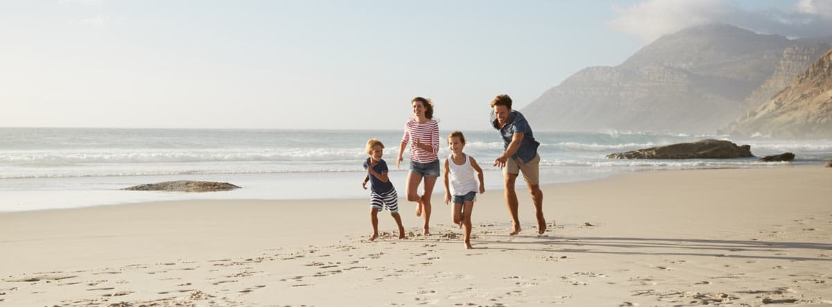 family running on a beach in Italy