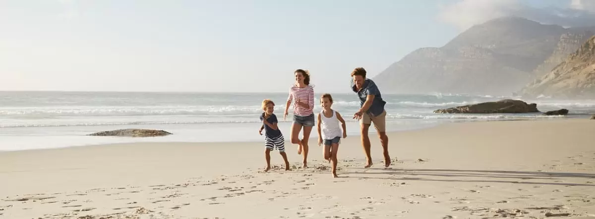 family running on a beach in Italy